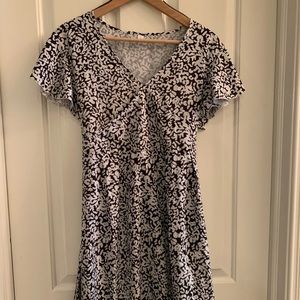 Black and white floral criss cross front mini dress tie back size large.